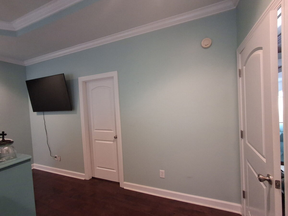 Master bedroom after remodel with new hardwood floors and fresh paint