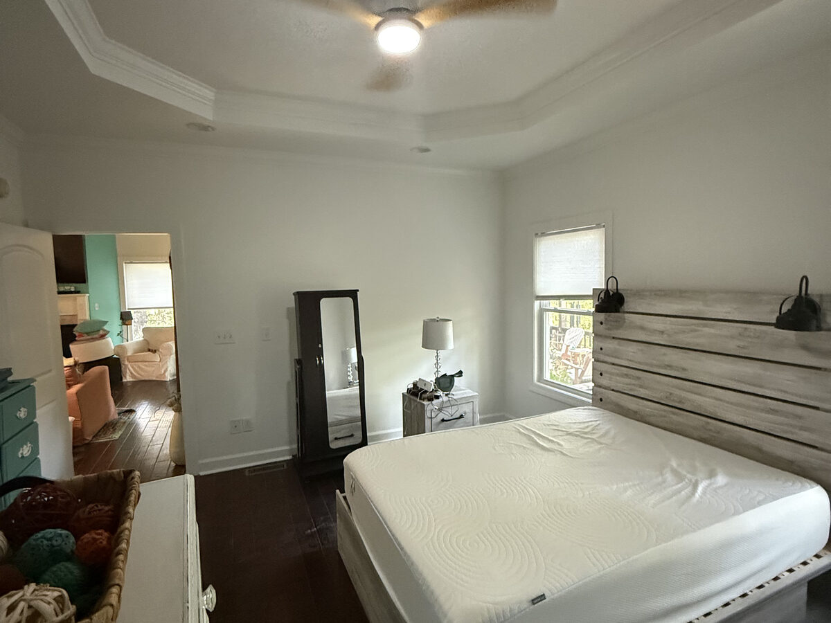 Finished master bedroom with tray ceiling and new hardwood floors