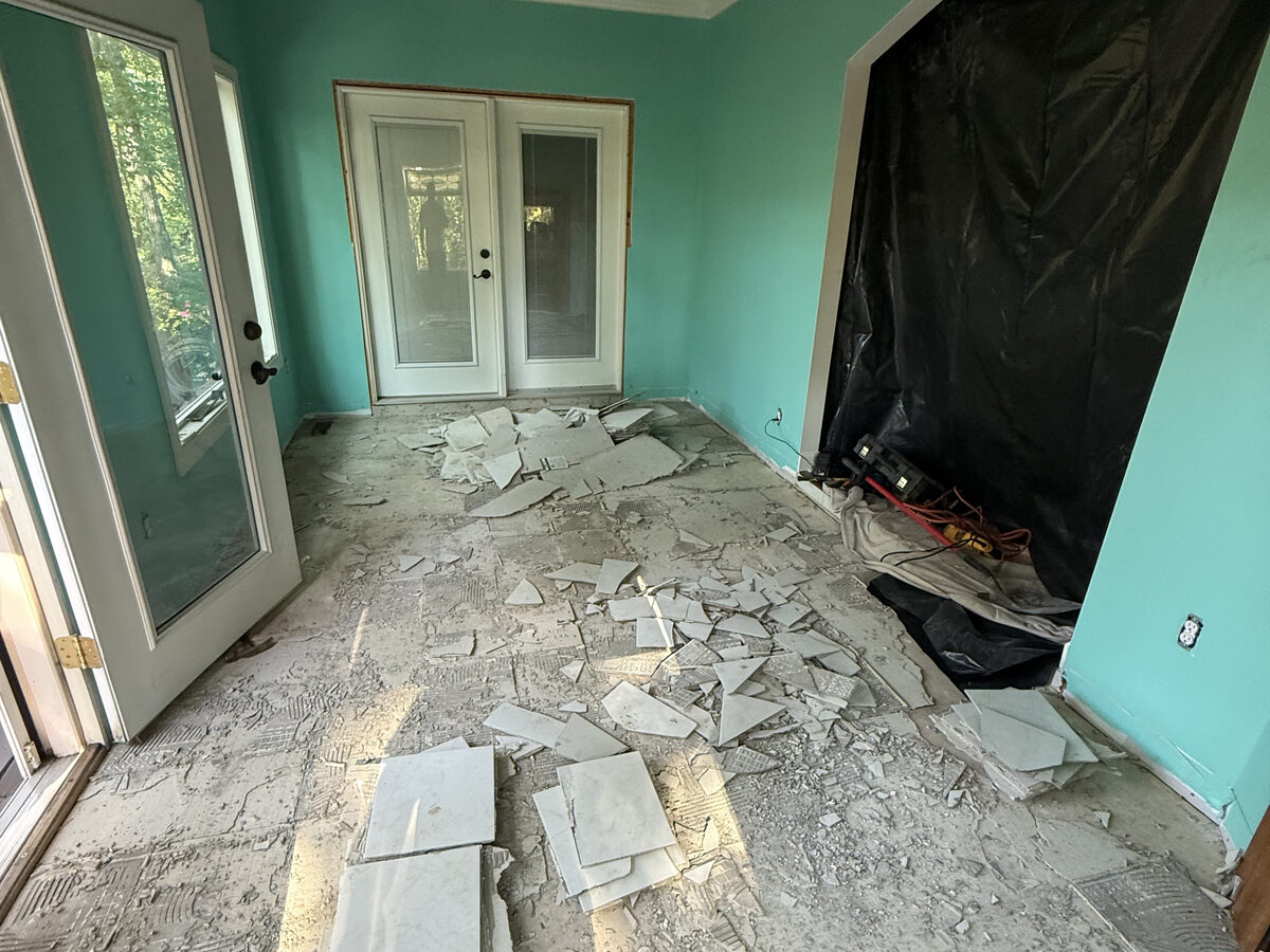 Living room before remodel, old flooring removed down to the subfloor