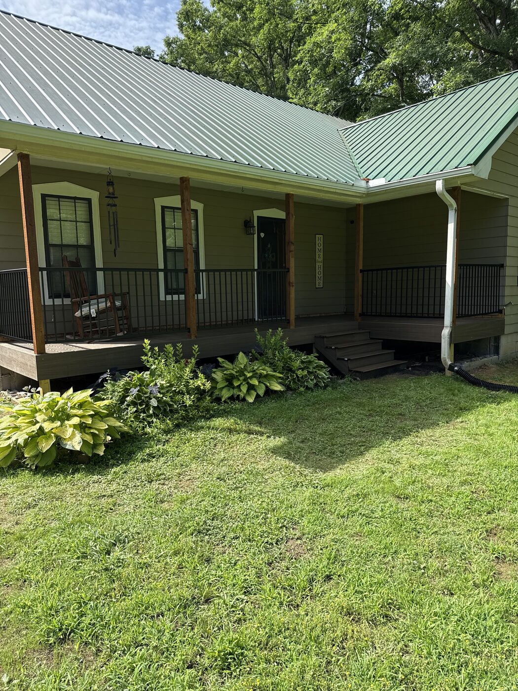 Covered front porch with composite decking, metal railing and metal roof
